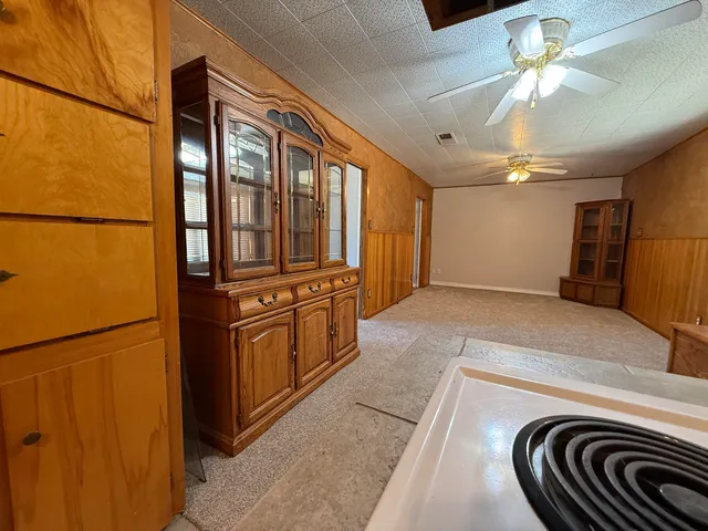 a kitchen with stainless steel appliances granite countertop a sink and a refrigerator
