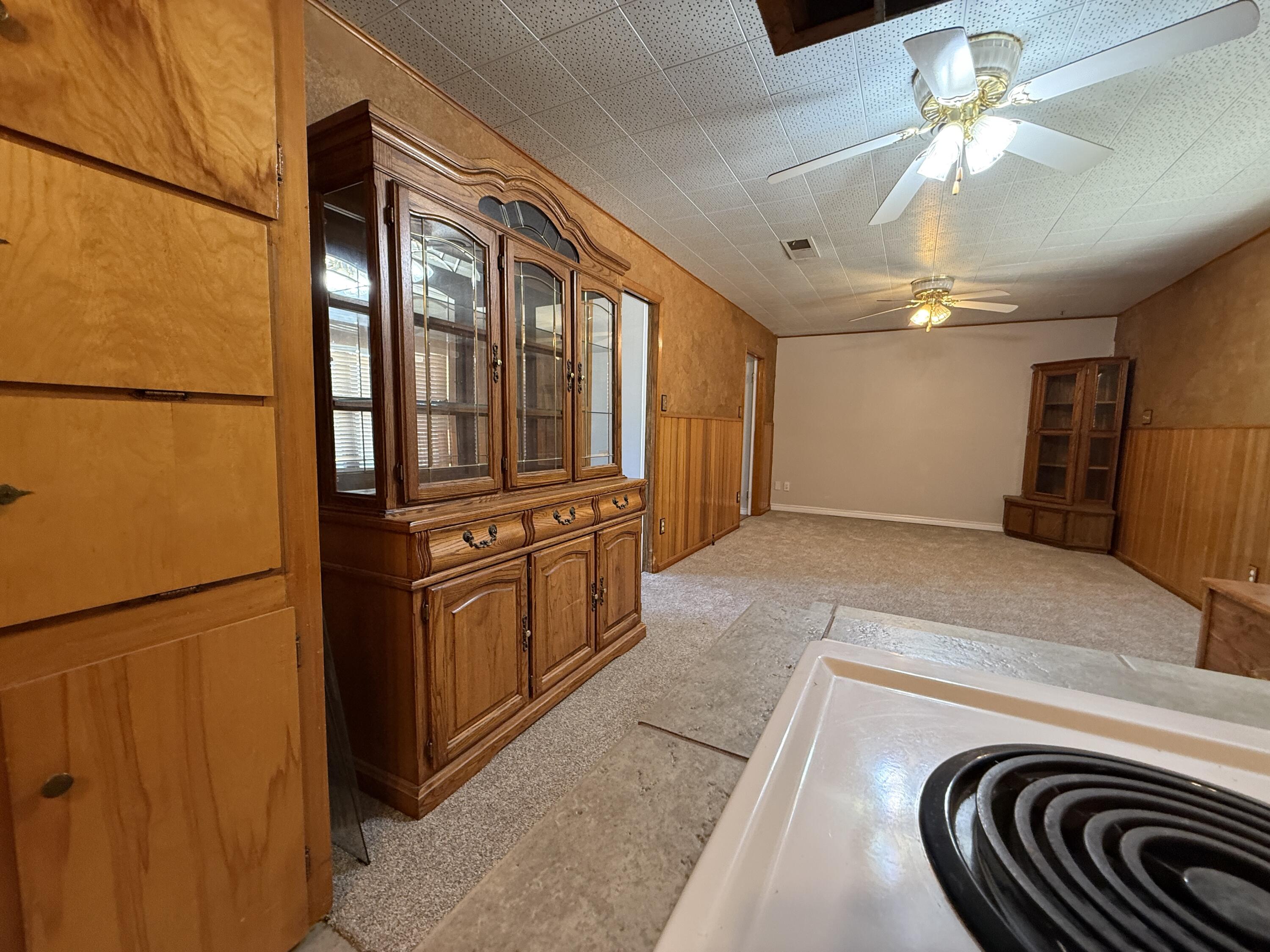 3391 Fisher Road Levelland, TX 79336 - Photo 12 of 47 a kitchen with stainless steel appliances granite countertop a refrigerator a stove and a sink with cabinets
