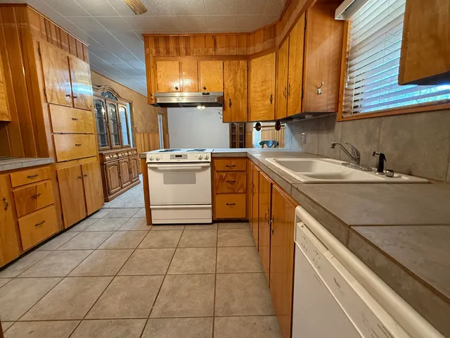 a kitchen with a refrigerator and a stove