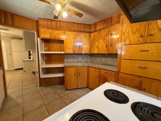 a kitchen with a sink a stove and cabinets