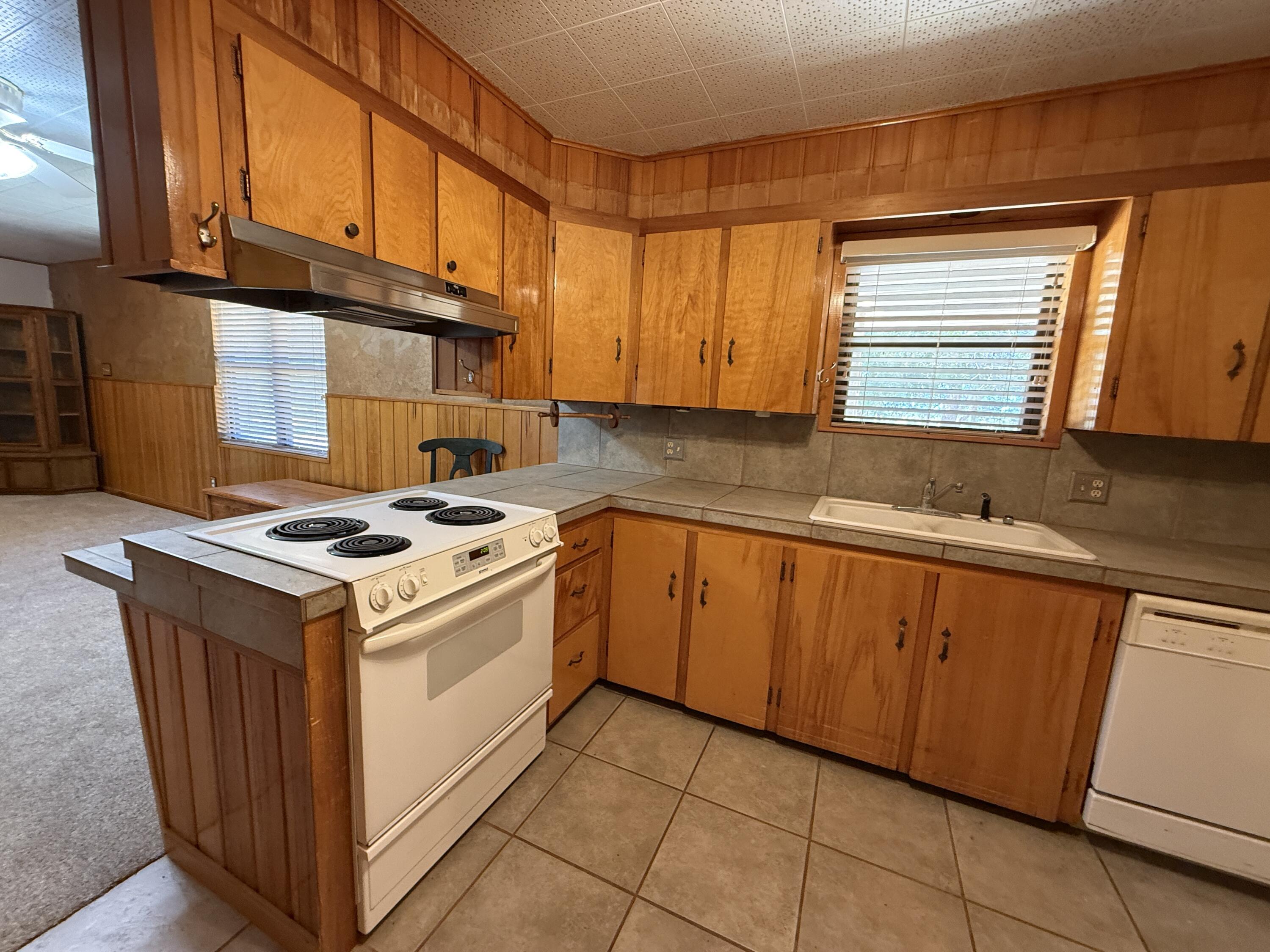 3391 Fisher Road Levelland, TX 79336 - Photo 17 of 47 a kitchen with stainless steel appliances granite countertop a stove and a sink