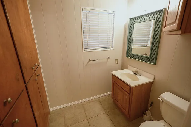 a bathroom with a sink a toilet and shower curtain