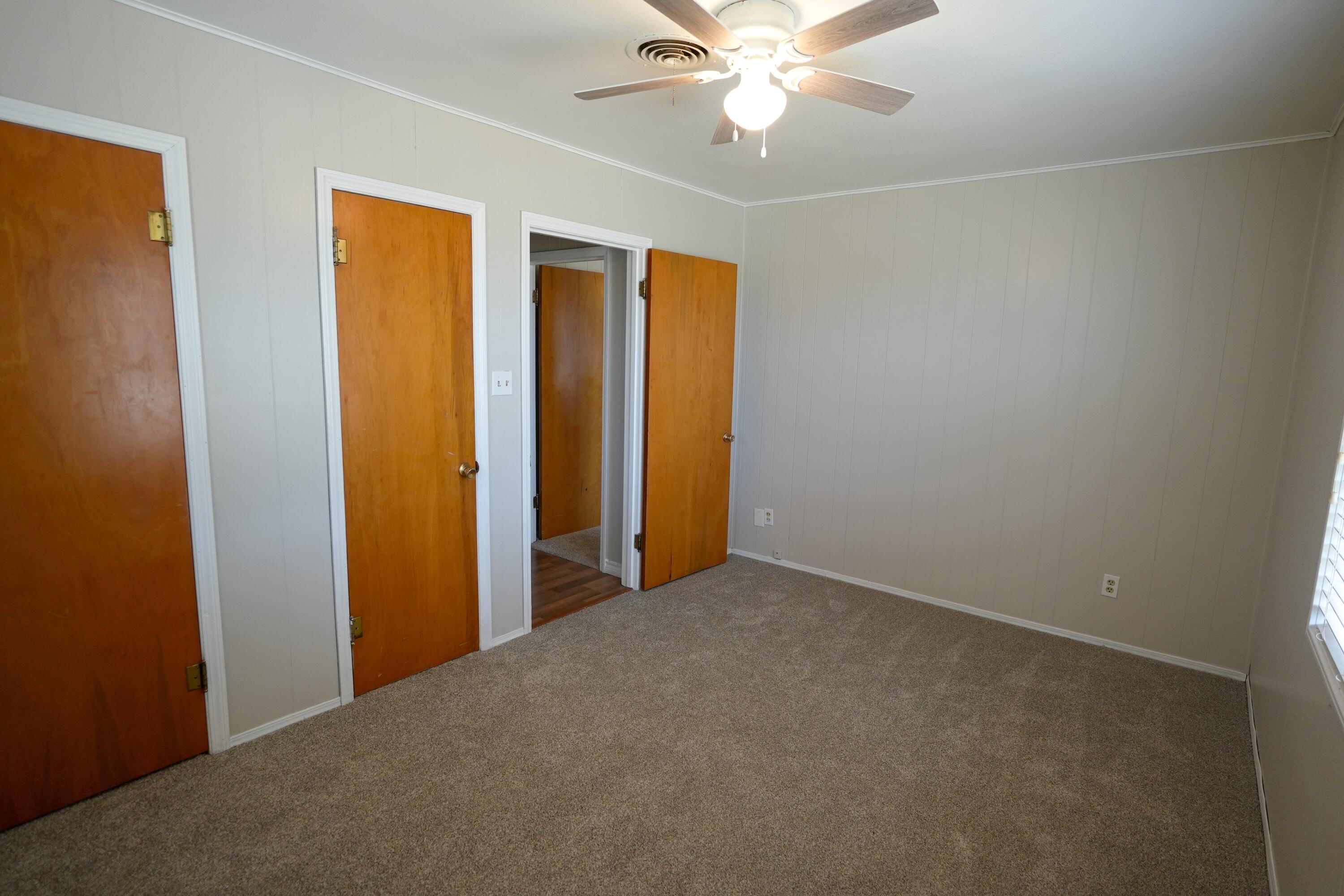 3391 Fisher Road Levelland, TX 79336 - Photo 24 of 47 an empty room with a chandelier fan and a closet