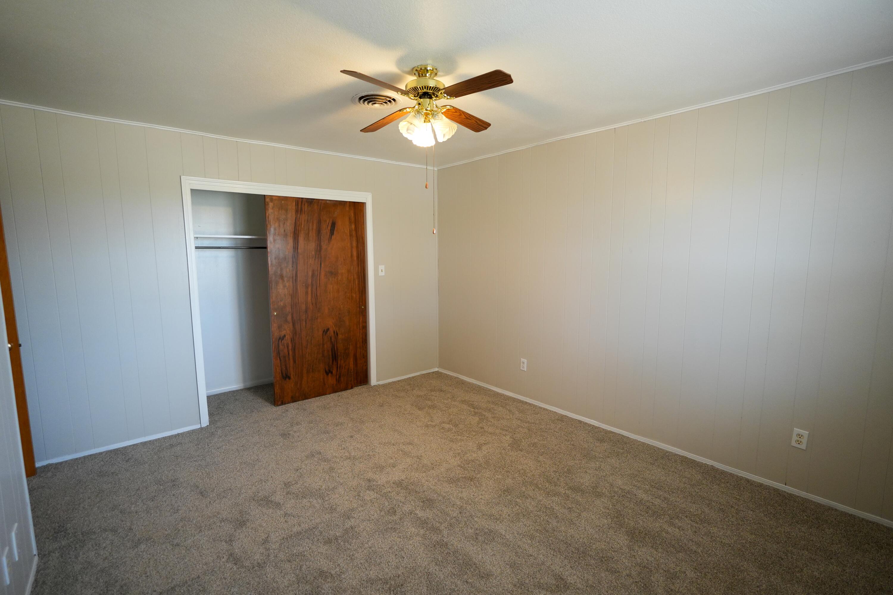 3391 Fisher Road Levelland, TX 79336 - Photo 25 of 47 an empty room with closet and a ceiling fan