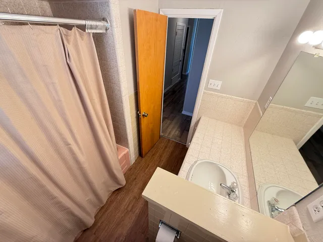 a bathroom with a sink a toilet and a mirror