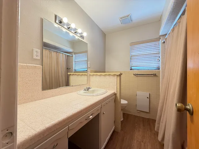 an empty room with closet and windows