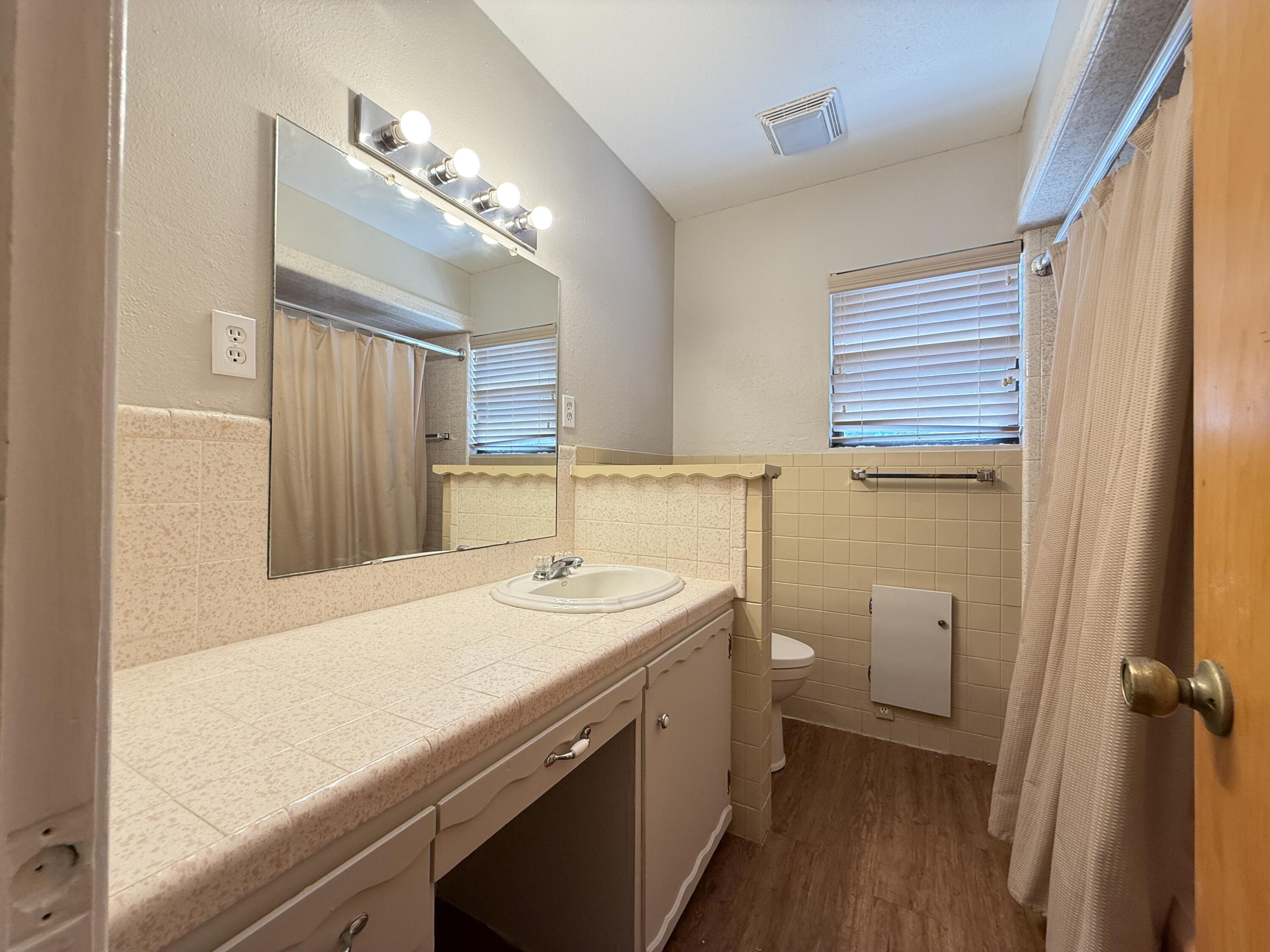 3391 Fisher Road Levelland, TX 79336 - Photo 30 of 47 a bathroom with a sink a toilet and a mirror