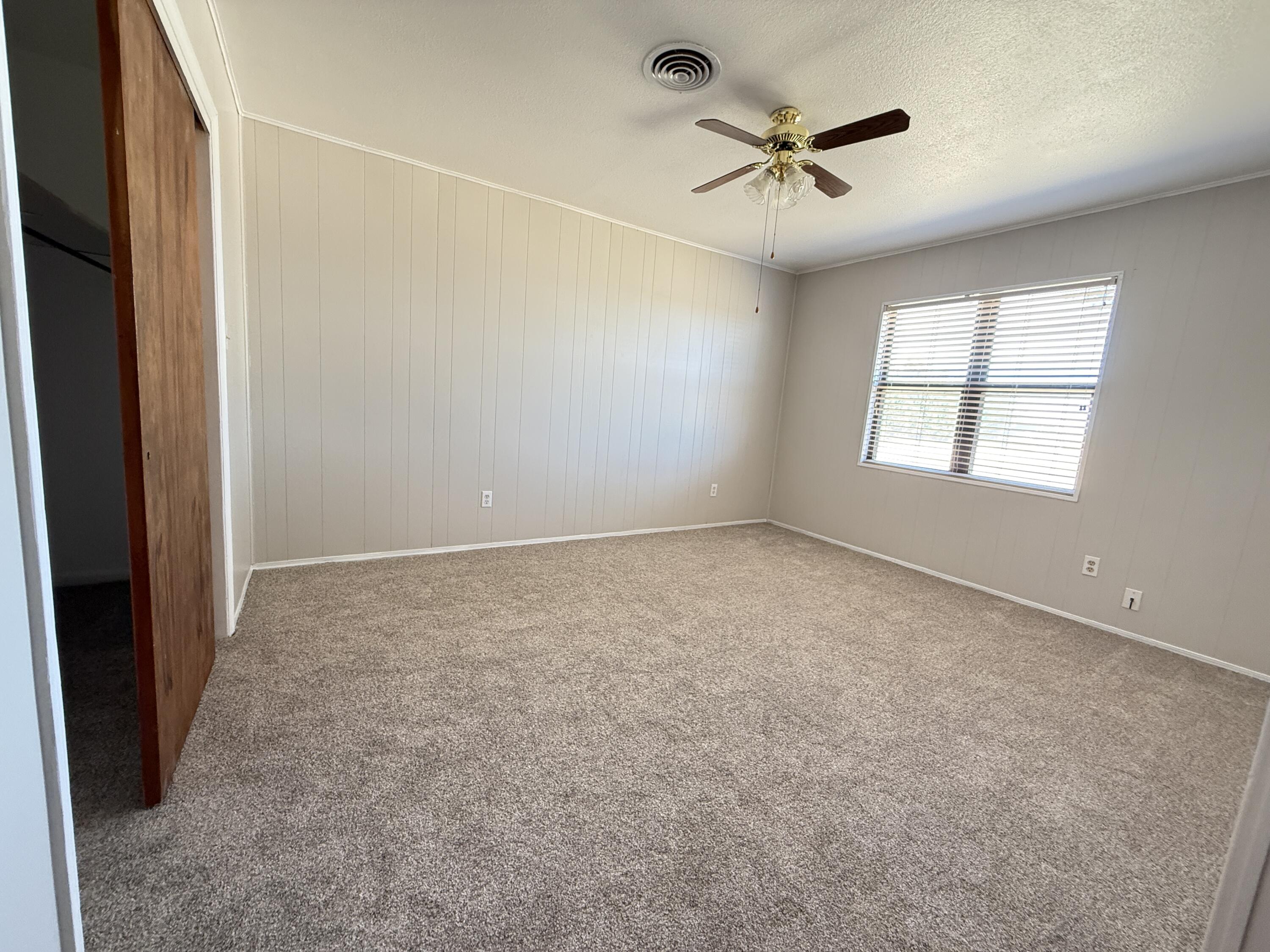 3391 Fisher Road Levelland, TX 79336 - Photo 32 of 47 an empty room with windows and ceiling fan