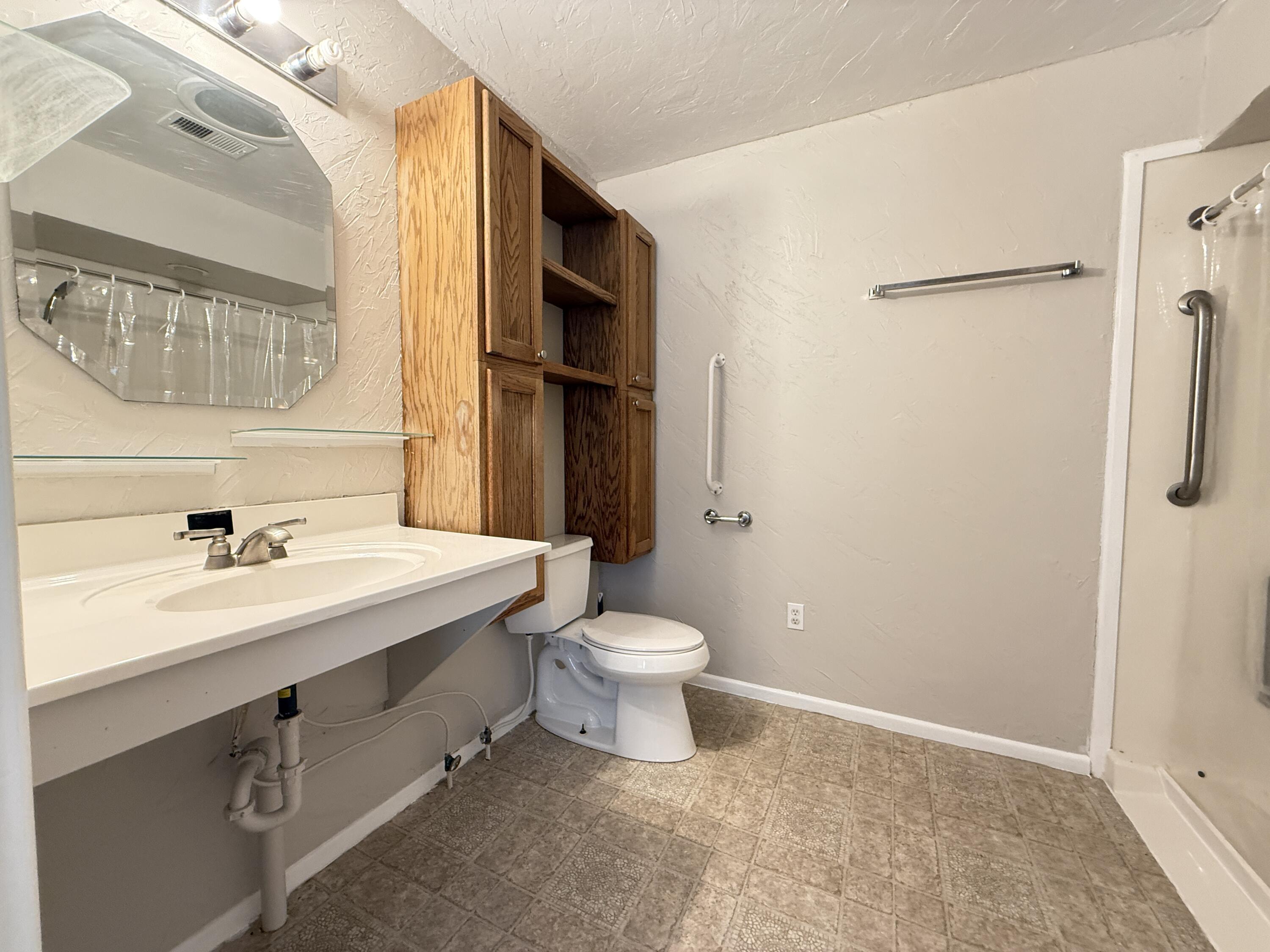 3391 Fisher Road Levelland, TX 79336 - Photo 33 of 47 a bathroom with a sink a toilet and shower