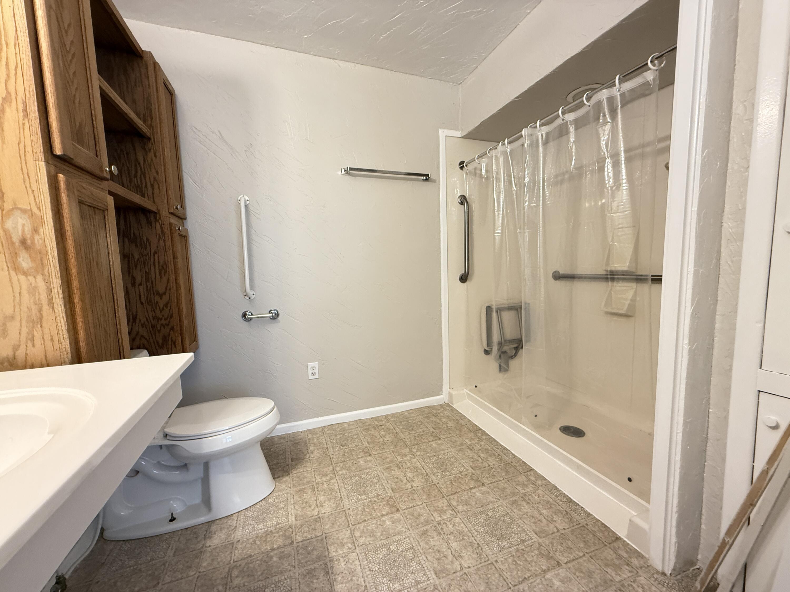 3391 Fisher Road Levelland, TX 79336 - Photo 34 of 47 a bathroom with a shower and a toilet