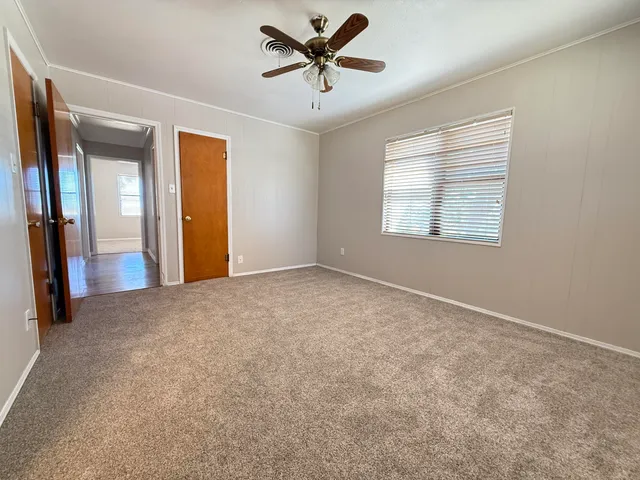 a view of room with a ceiling fan and window