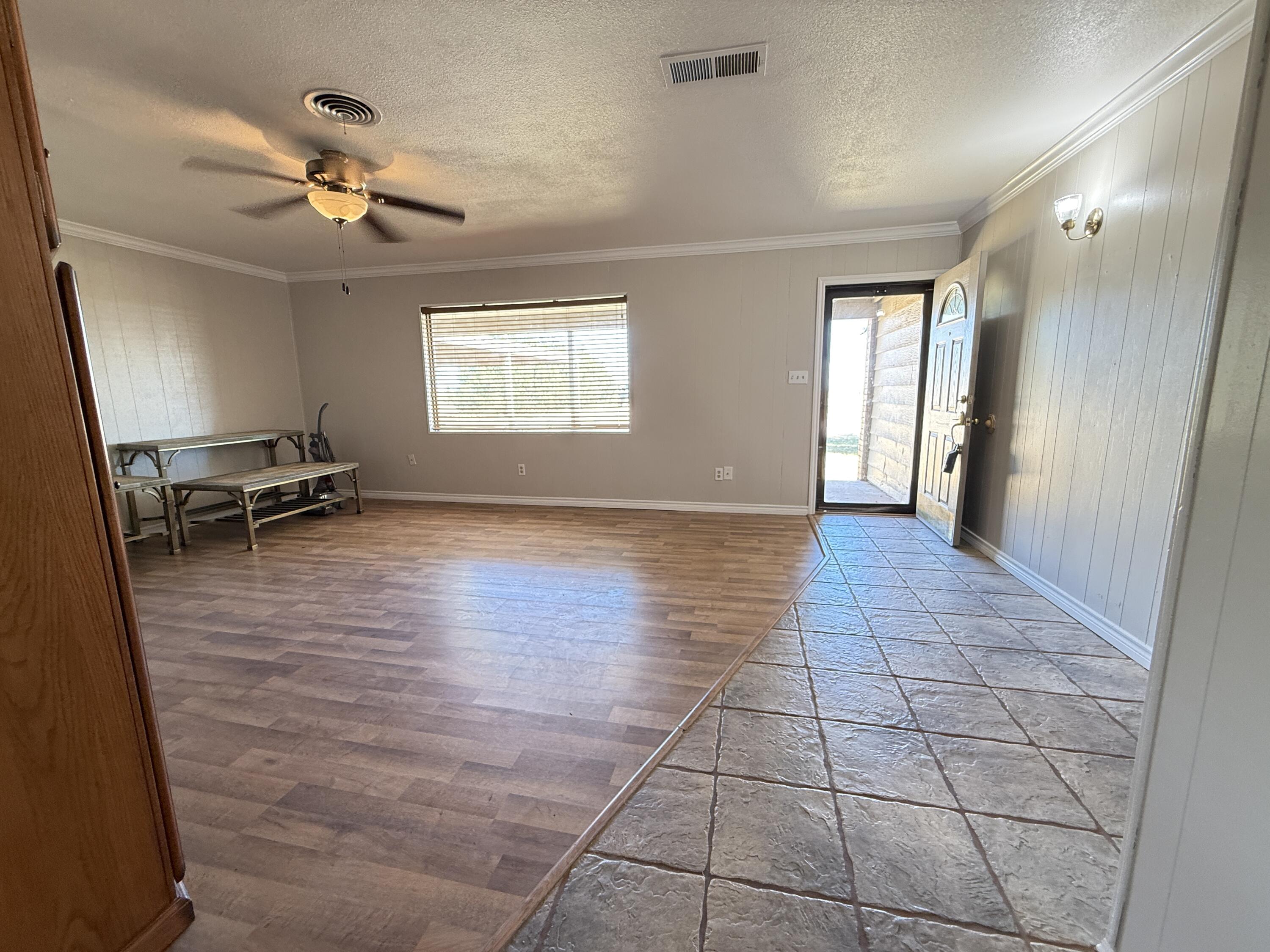 3391 Fisher Road Levelland, TX 79336 - Photo 6 of 47 wooden floor in an empty room with a window