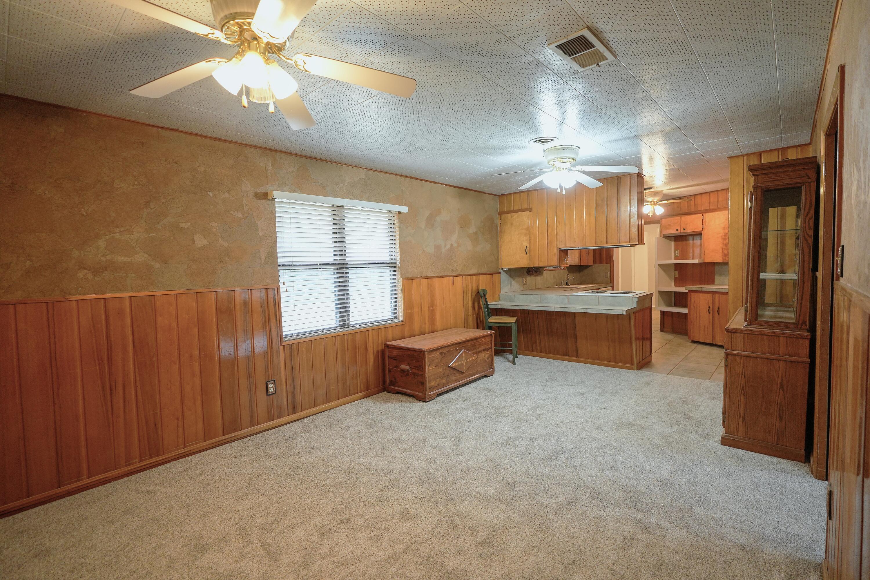 3391 Fisher Road Levelland, TX 79336 - Photo 7 of 47 a living room with stainless steel appliances kitchen island granite countertop furniture and a large window