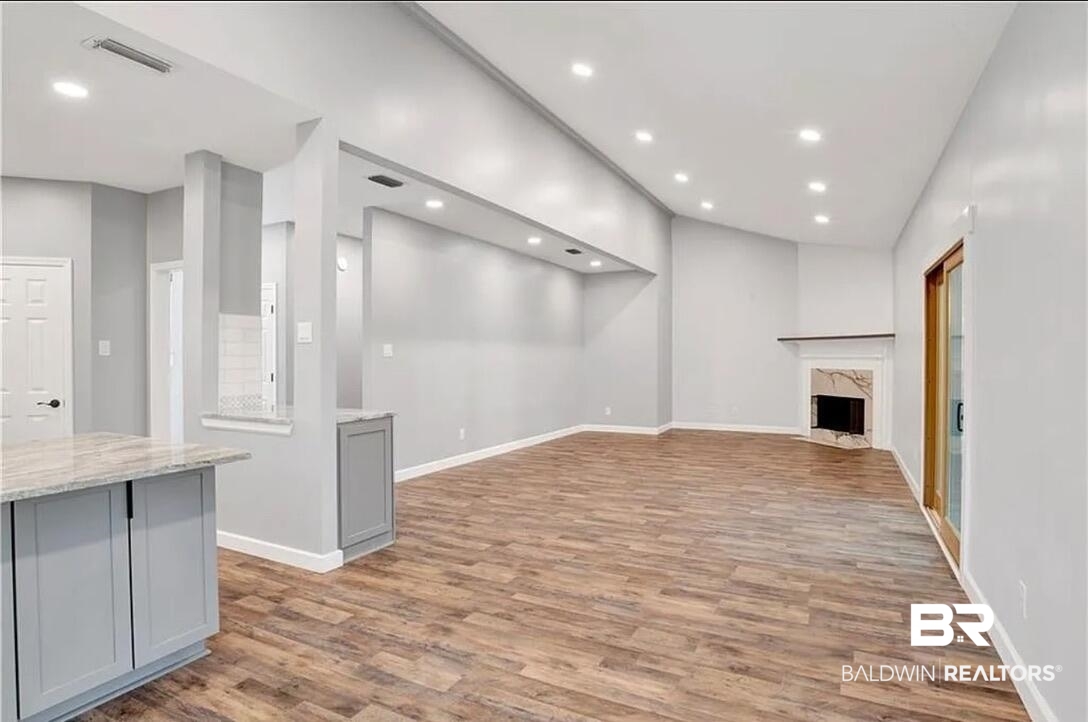 632 Ridgewood Drive Daphne, AL 36526 - Photo 17 of 36 Unfurnished living room featuring a fireplace and light hardwood / wood-style floors