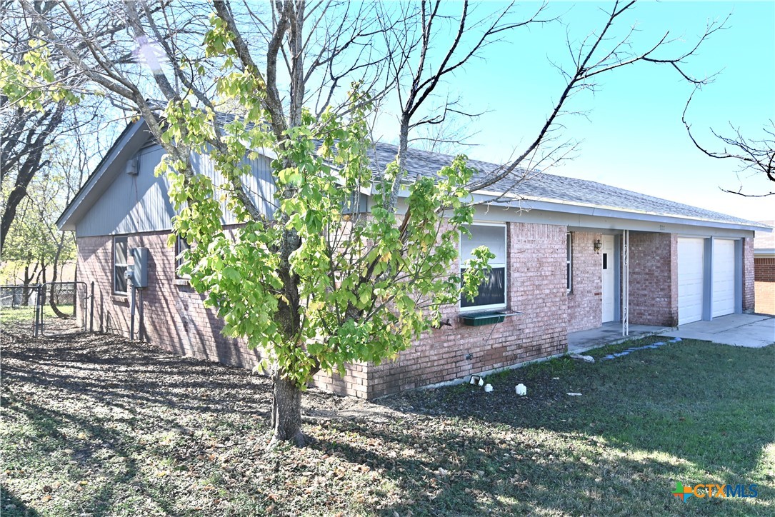 928 Randa Street Copperas Cove, TX 76522 - Photo 2 of 19 a view of a yard in front of a house with large tree