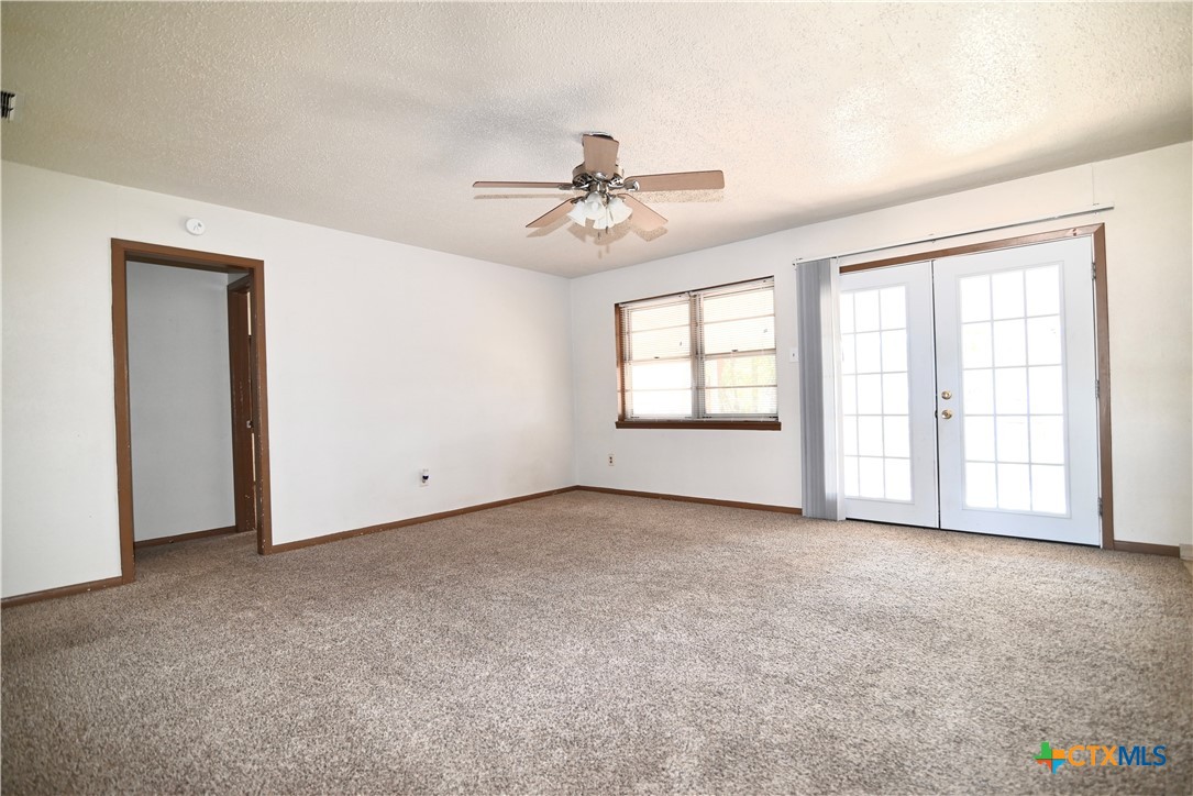 928 Randa Street Copperas Cove, TX 76522 - Photo 4 of 19 an empty room with windows and ceiling fan view
