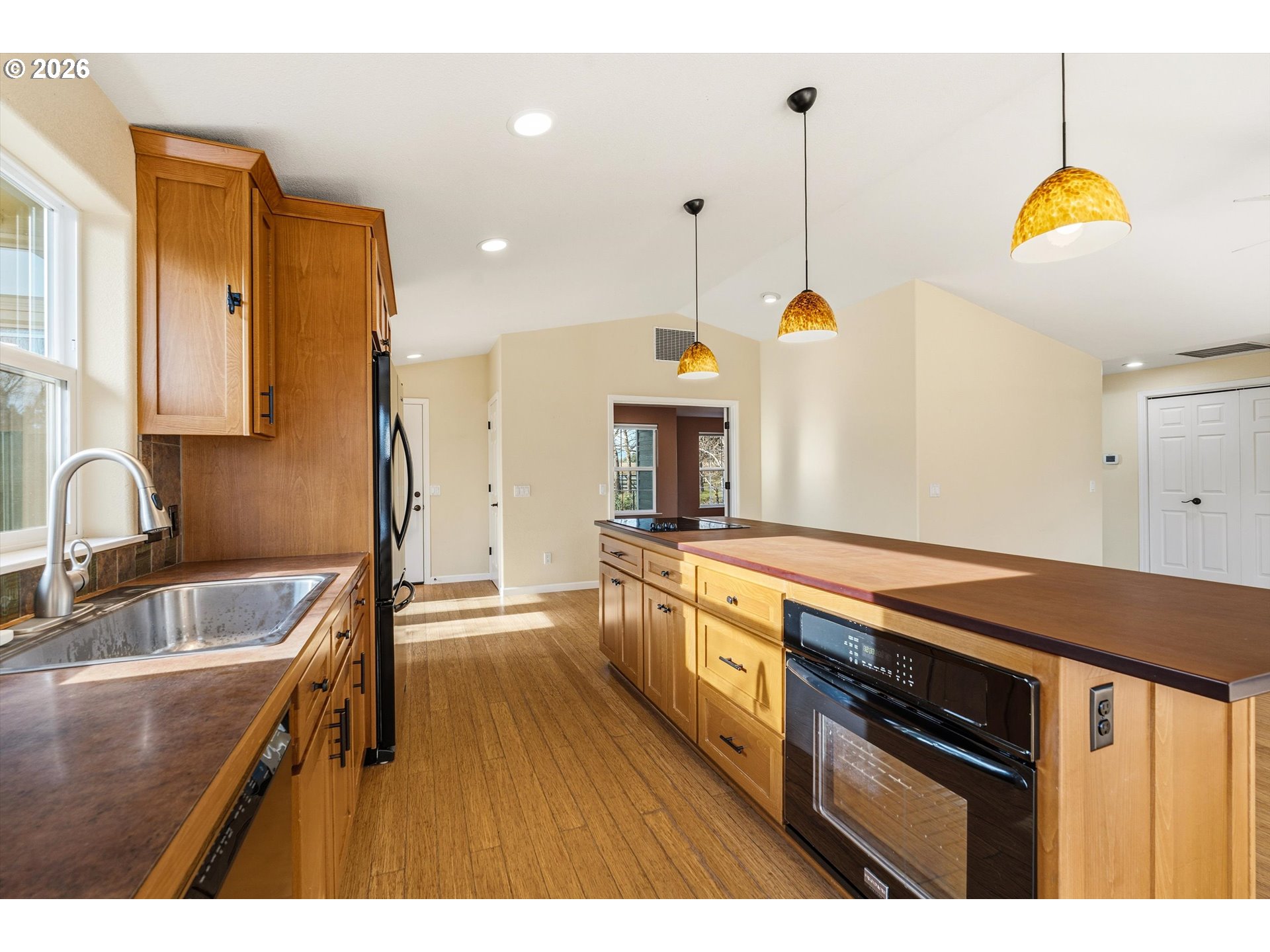 30303 Bellfountain Road Corvallis, OR 97333 - Photo 11 of 47 a kitchen with granite countertop a sink a stove and a wooden floors