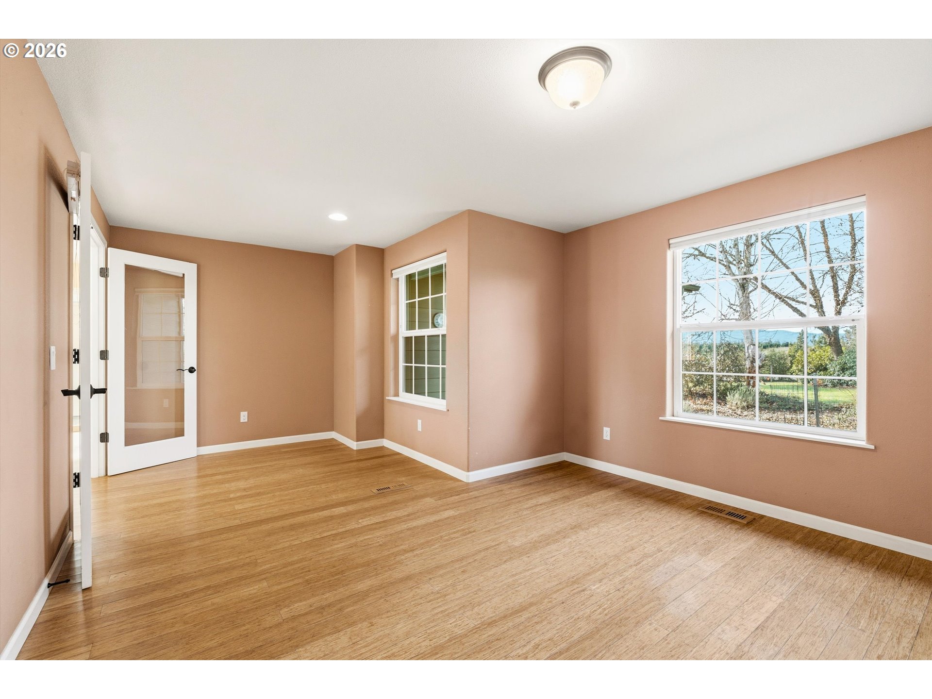 30303 Bellfountain Road Corvallis, OR 97333 - Photo 27 of 47 an empty room with wooden floor and windows