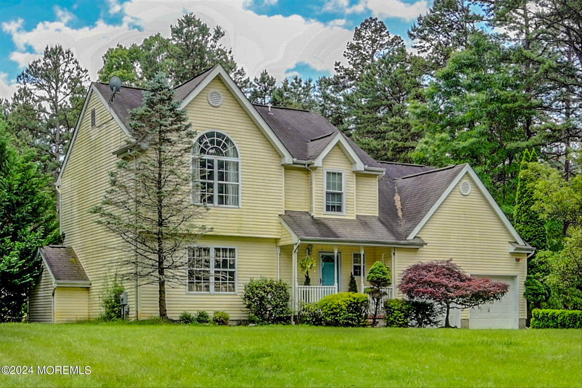 227 East Pleasant Grove Road Jackson, NJ 08527 - Photo 8 of 53 a front view of a house with a garden and plants