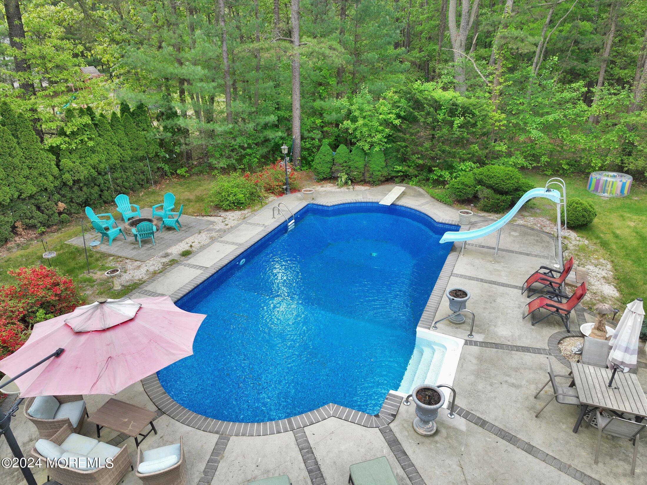 227 East Pleasant Grove Road Jackson, NJ 08527 - Photo 9 of 53 a view of a backyard with table and chairs potted plants