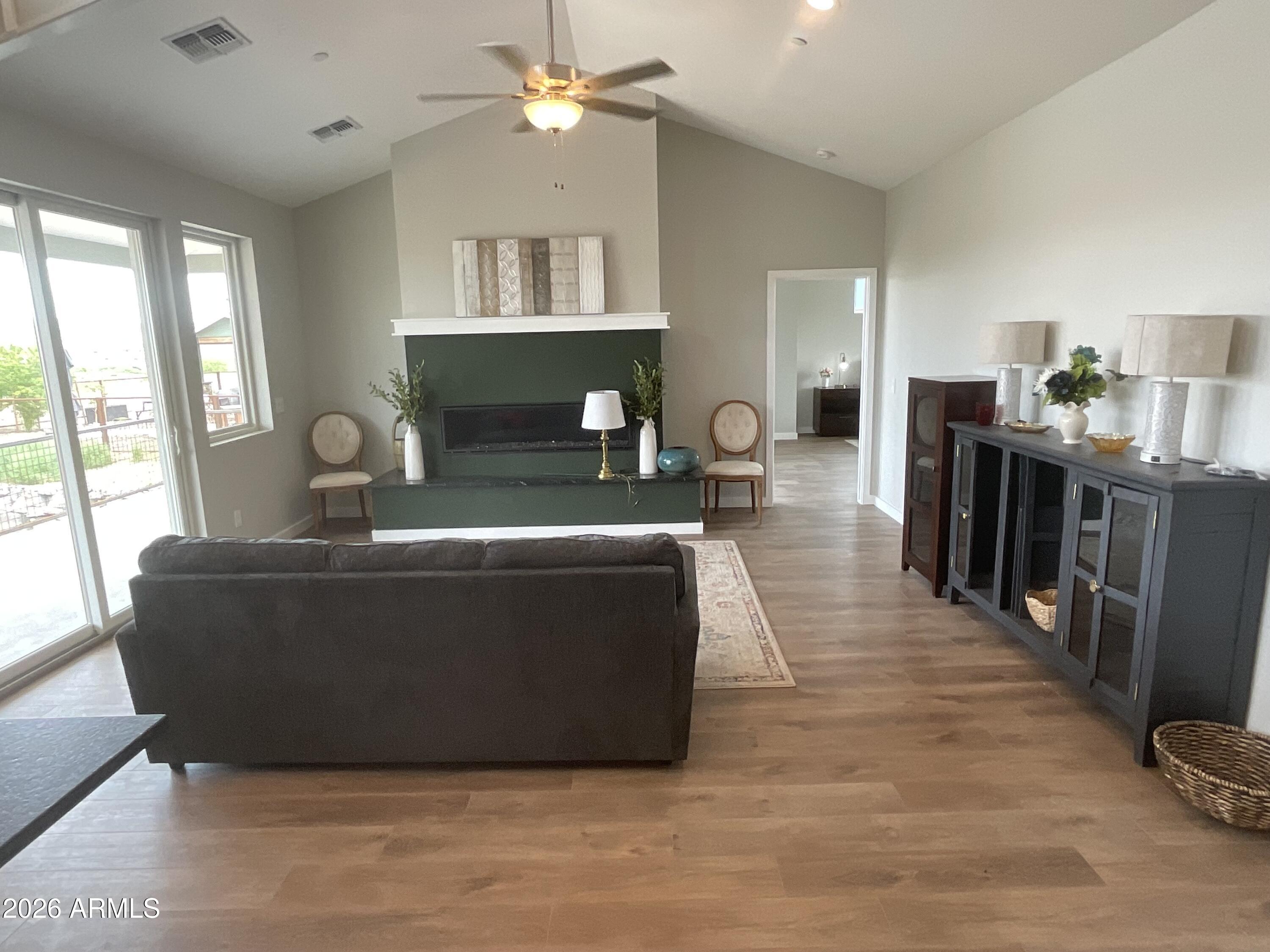 498 Kindra Heights Road Cottonwood, AZ 86326 - Photo 7 of 37 a living room with furniture a fireplace and a large window