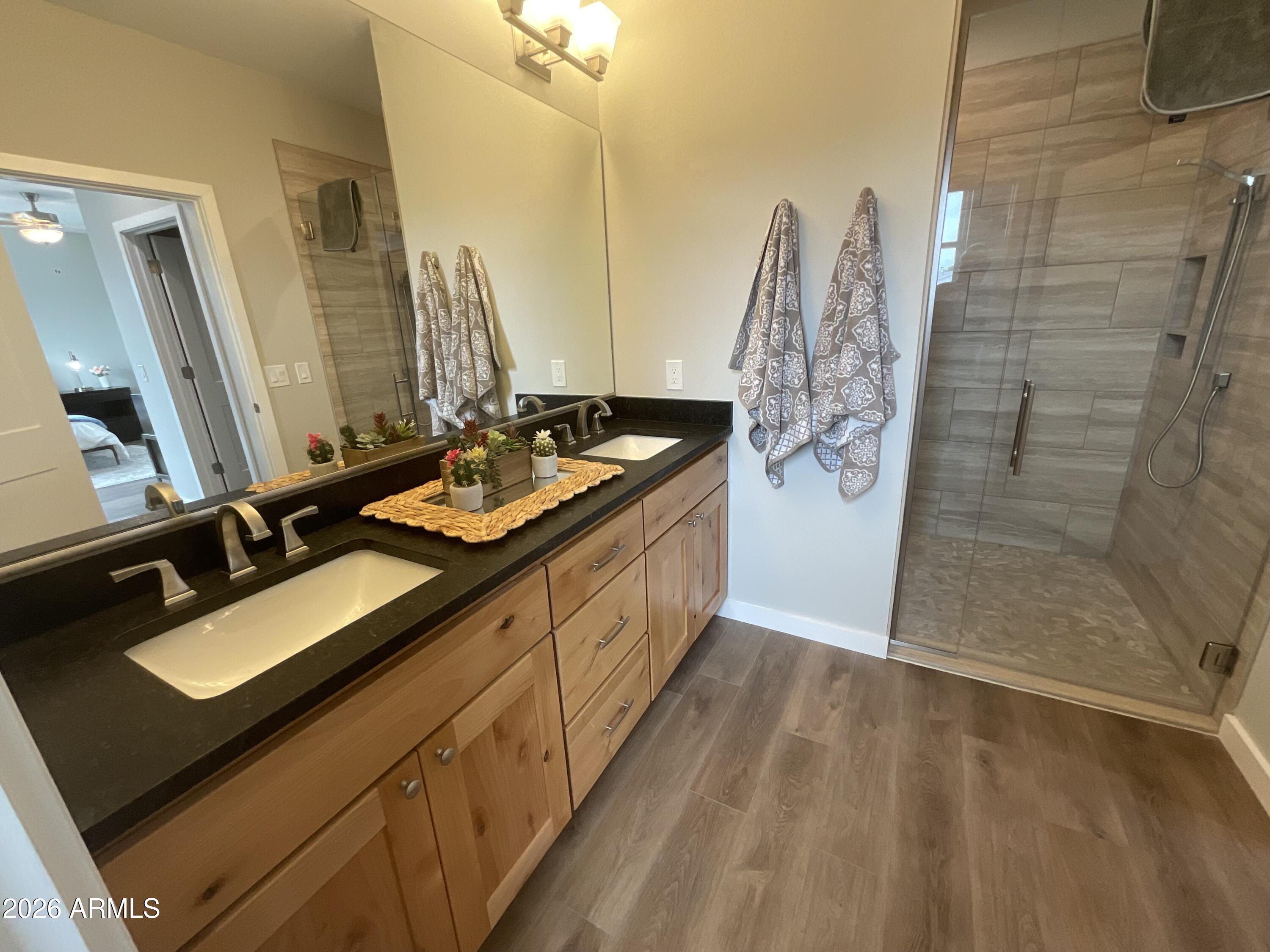 498 Kindra Heights Road Cottonwood, AZ 86326 - Photo 10 of 37 a bathroom with a double vanity sink a and mirror