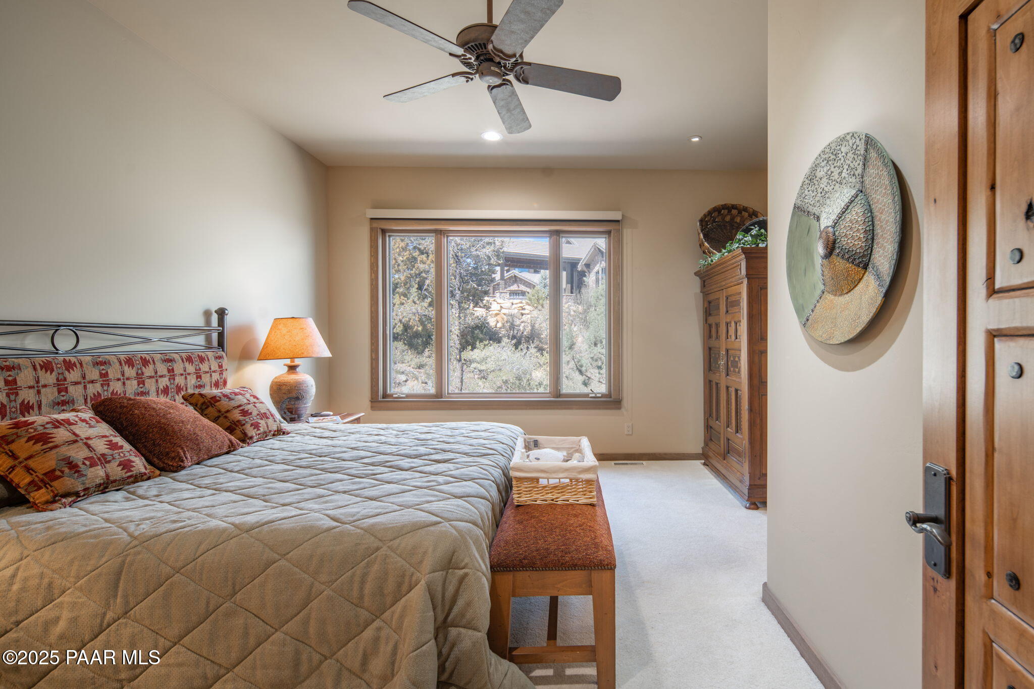 2158 Forest Mountain Road Prescott, AZ 86303 - Photo 45 of 68 a bedroom with a bed a mirror on the wall and a large window