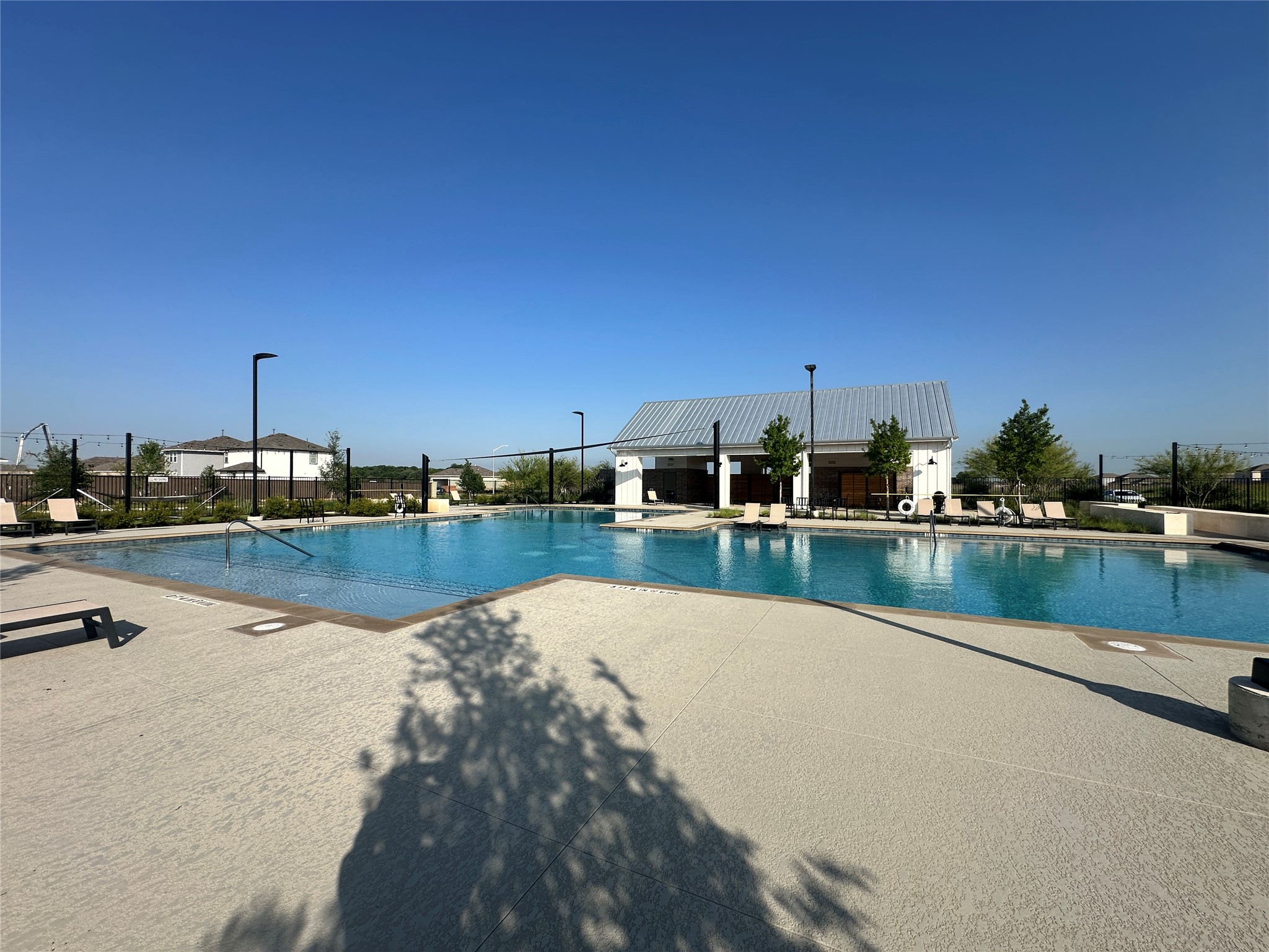 274 Jade Street Maxwell, TX 78656 - Photo 28 of 36 a view of swimming pool with table and chairs under an umbrella