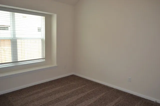 a view of an empty room with closet area