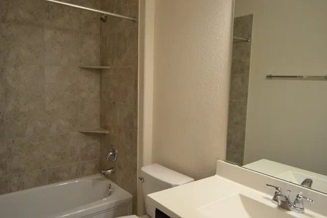 a bathroom with a bathtub and shower