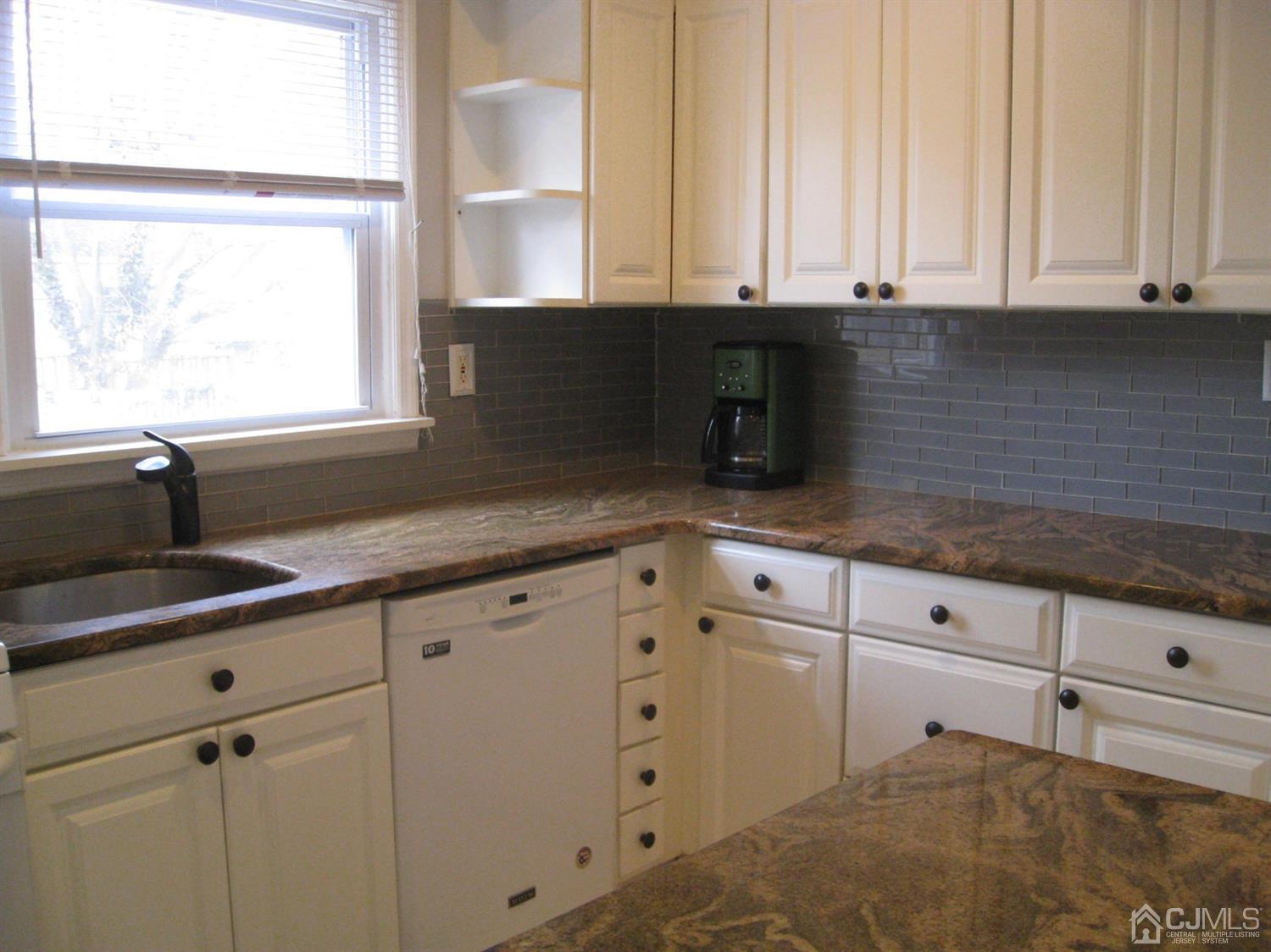 85 Willow Road Metuchen, NJ 08840 - Photo 7 of 21 Kitchen with granite counter top, glass tile back splash and breakfast bar.