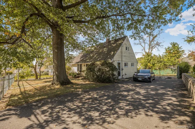a view of a house with a tree in the background