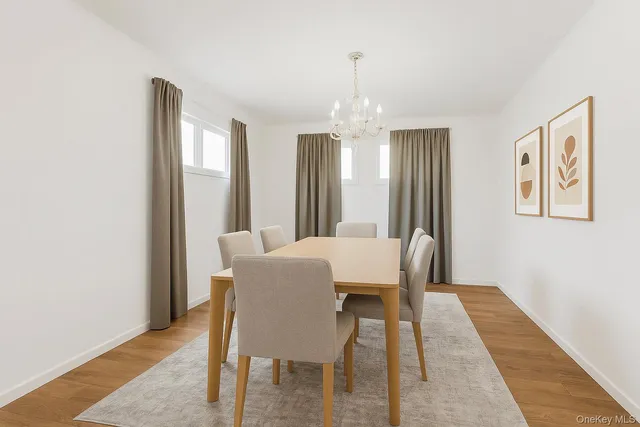 a view of a dining room with furniture and a chandelier