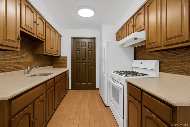 a kitchen with a stove a sink and a refrigerator