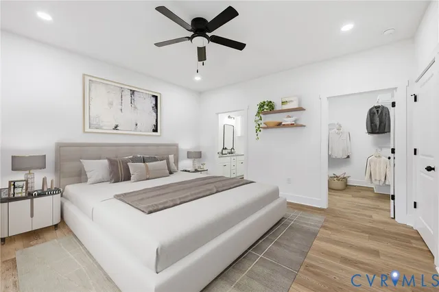 a bedroom with a large bed and a chandelier