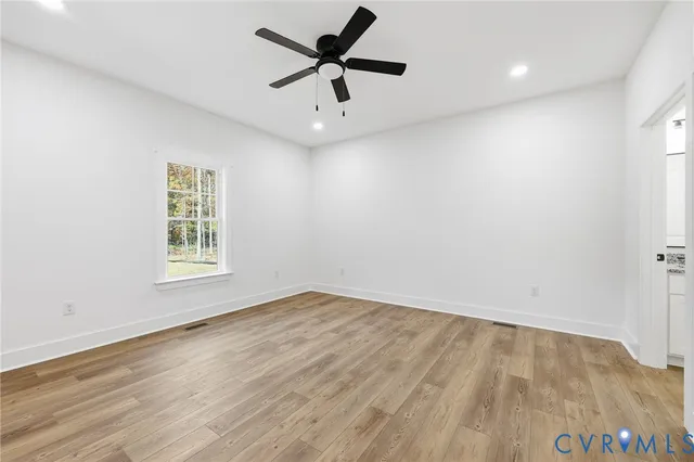 wooden floor in an empty room with a window