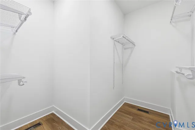 a view of a room with wooden floor and white walls