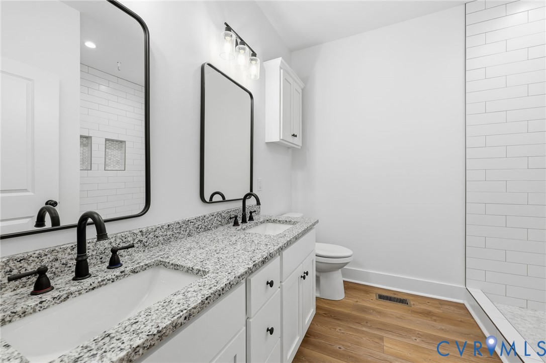 5888 Cartersville Road New Canton, VA 23123 - Photo 19 of 33 a bathroom with a granite countertop sink and a mirror