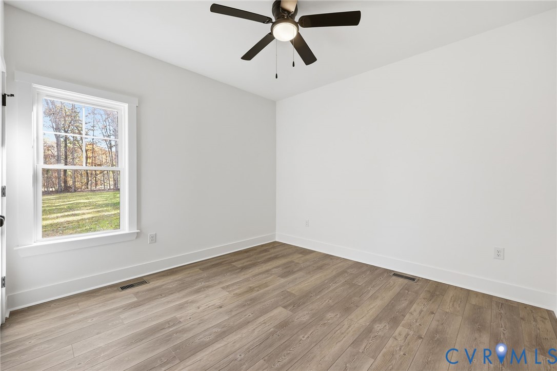 5888 Cartersville Road New Canton, VA 23123 - Photo 22 of 33 a view of empty room with wooden floor and fan