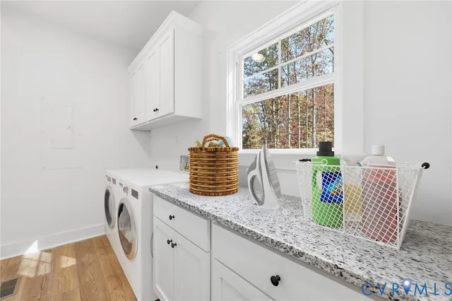 a kitchen with granite countertop white cabinets and a window