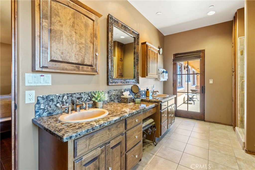 725 Spring Creek Way Templeton, CA 93465 - Photo 25 of 70 a bathroom with a granite countertop sink and a mirror