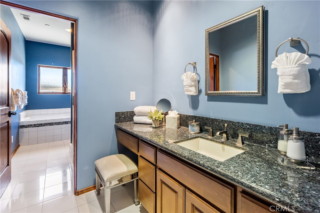 725 Spring Creek Way Templeton, CA 93465 - Photo 30 of 70 a bathroom with a sink and a mirror