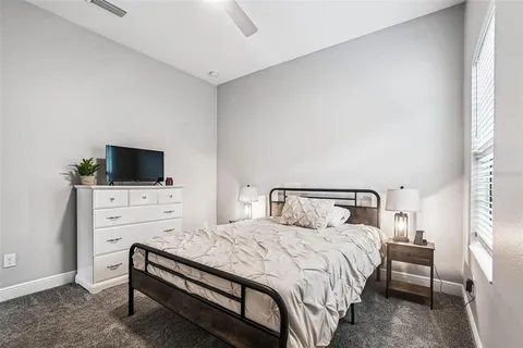 a utility room with stainless steel appliances white cabinets and a stove
