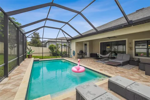 a view of a backyard with swimming pool