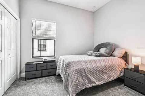 a living room with furniture a chandelier and a window