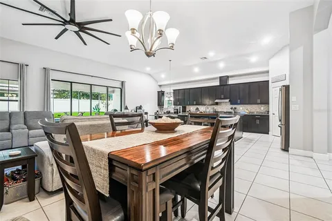 a kitchen with granite countertop a counter space chairs stainless steel appliances and cabinets