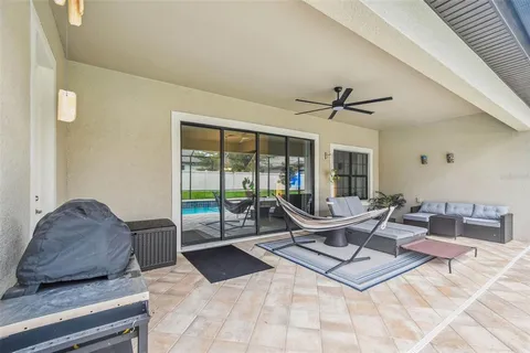 a view of a patio with table and chairs and potted plants