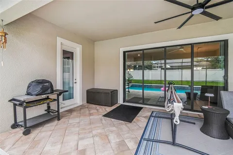 a view of a backyard with swimming pool and furniture
