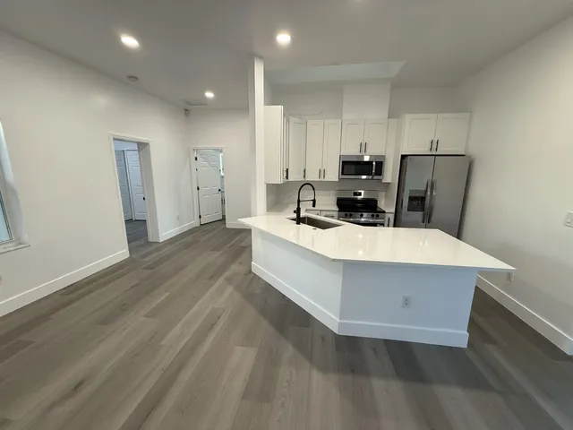 a kitchen with a sink a stove and a refrigerator