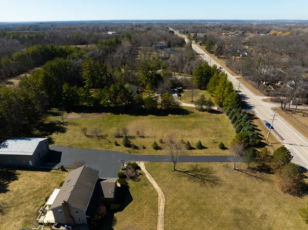 an aerial view of a house with a yard